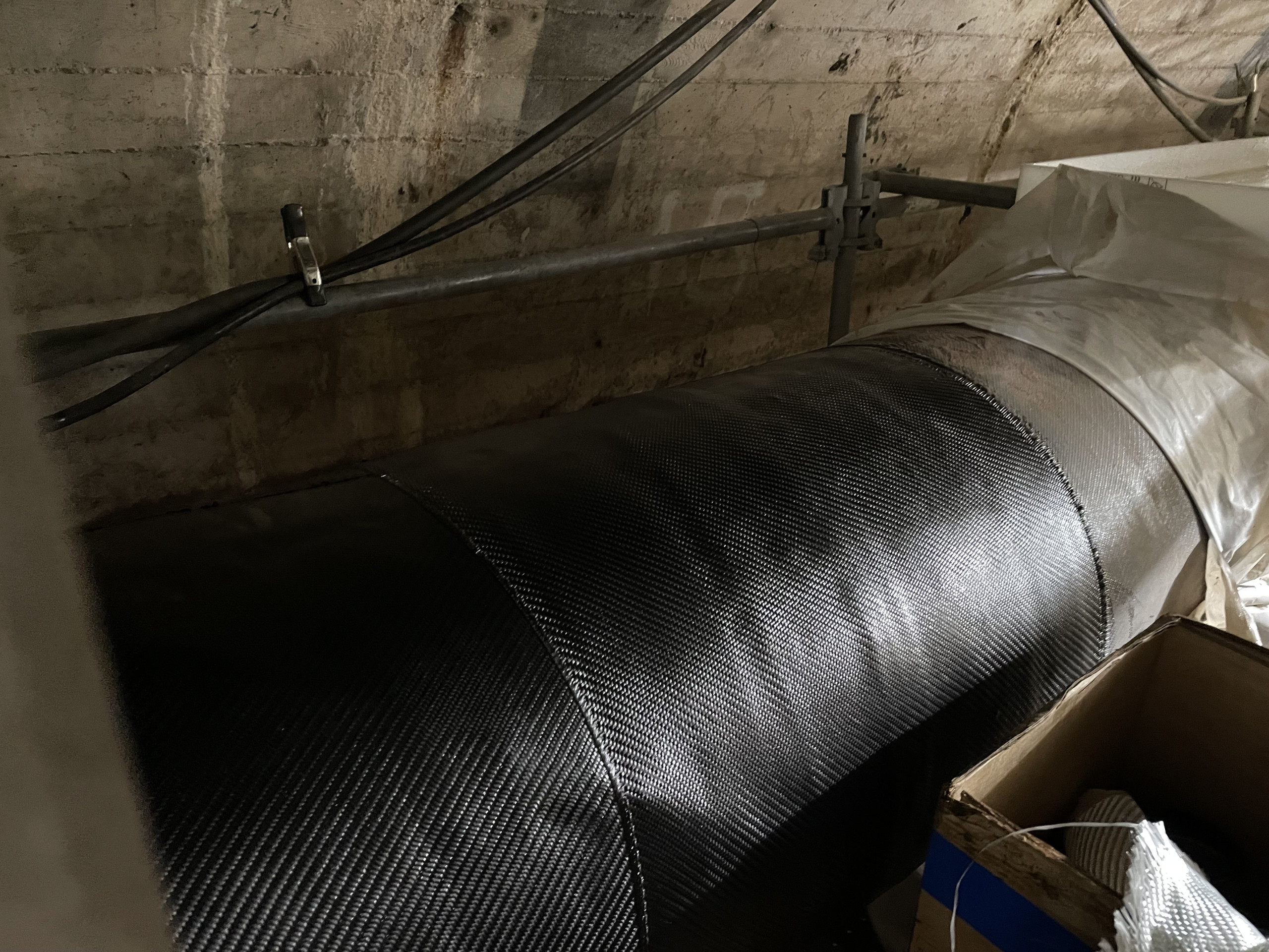 Picture of underground natural gas pipeline with successful composite wrap repair applied.