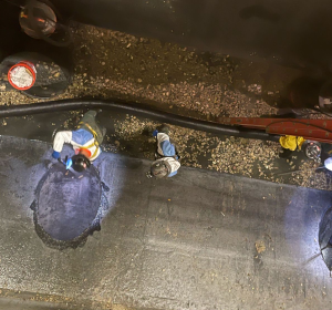 Aerial view of multiple workers repairing concrete.