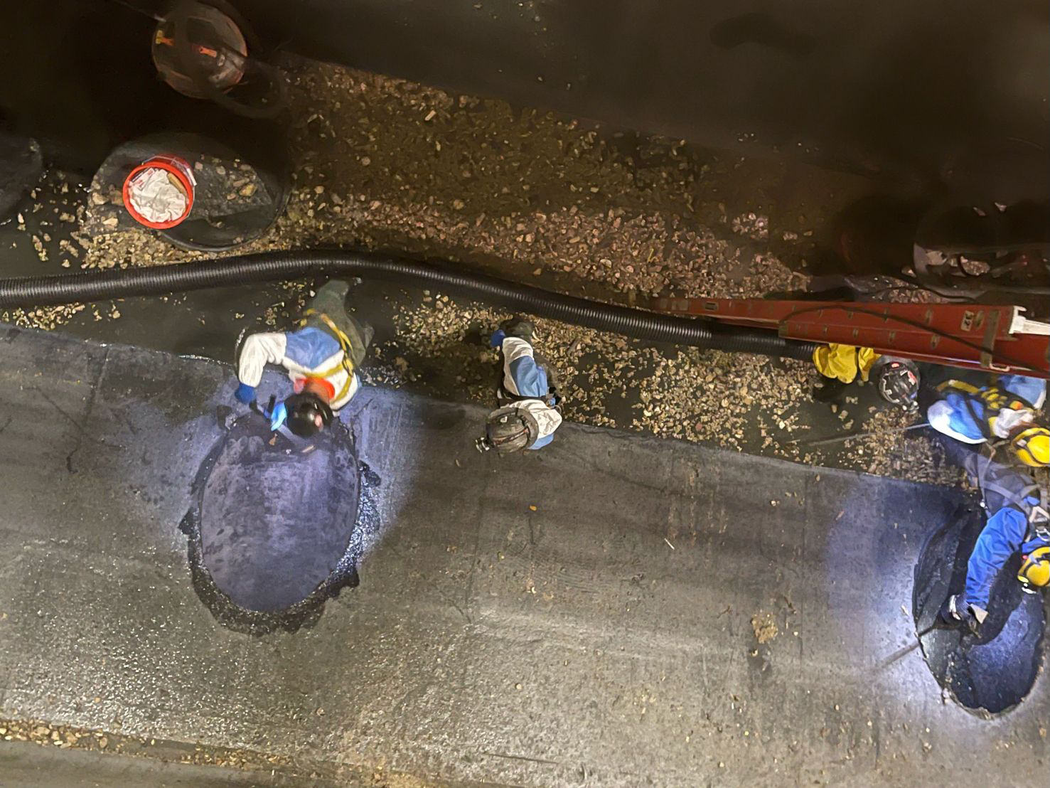 Aerial view of multiple workers repairing concrete.