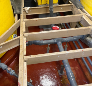 Containment area covered with freshly applied red coating.