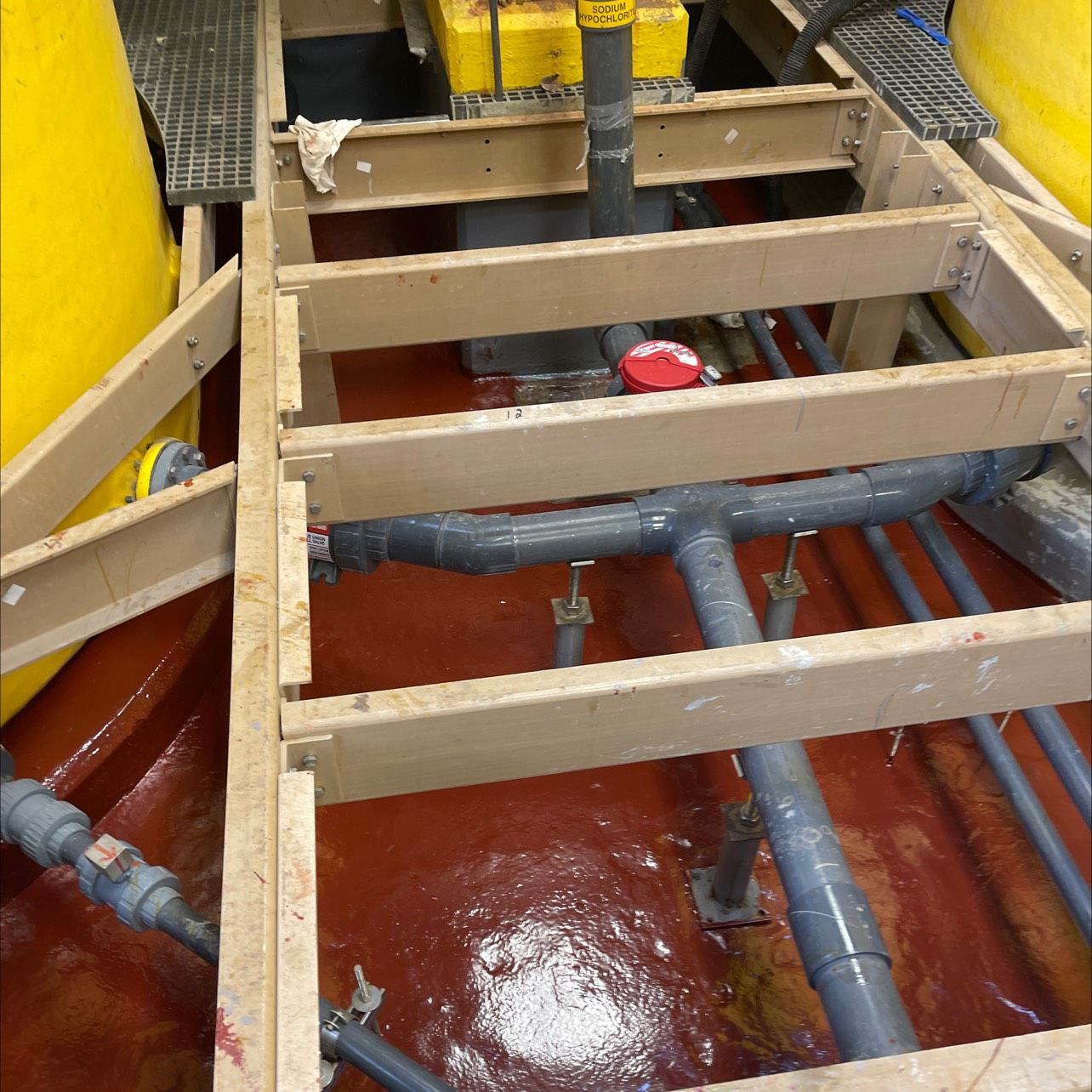 Containment area covered with freshly applied red coating.