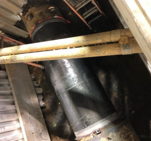 Birds-eye view of large pipeline in a trench with a composite wrap repair.