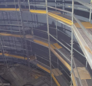 Scaffolding against the wall inside a spray dry absorber to paint industrial coating.