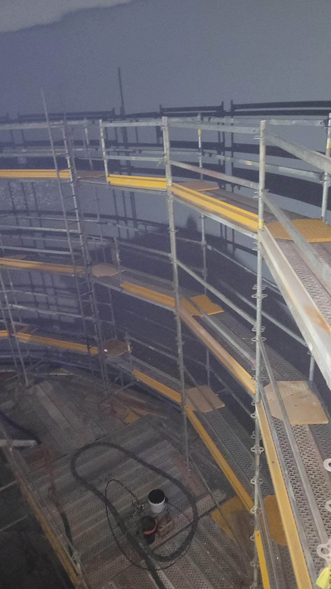 Scaffolding against the wall inside a spray dry absorber to paint industrial coating.