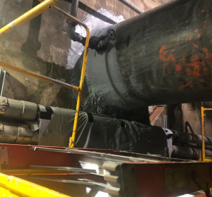 Raw sewage intake pipe coming through concrete wall.