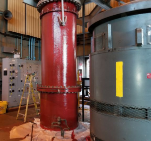 Raw sewage intake pipe painted with red primer.