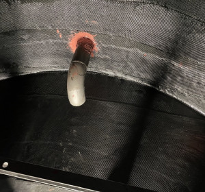 Bottom of tank covered with carbon fiber composite wrap on the floor and walls of the tank interior