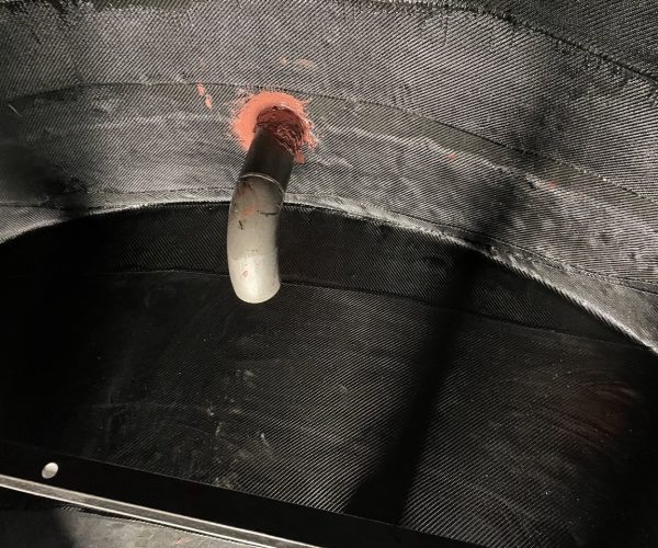Bottom of tank covered with carbon fiber composite wrap on the floor and walls of the tank interior