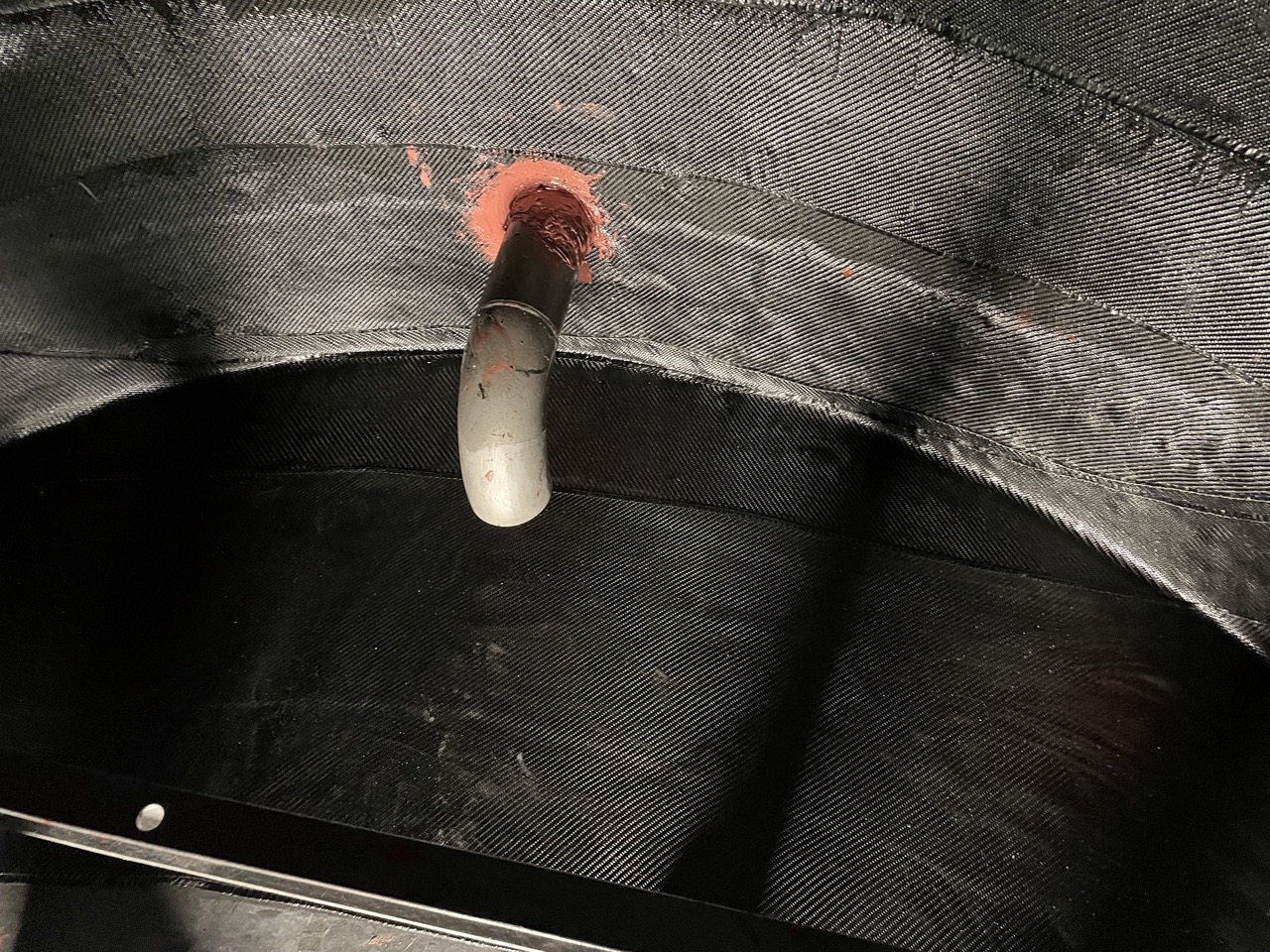 Bottom of tank covered with carbon fiber composite wrap on the floor and walls of the tank interior