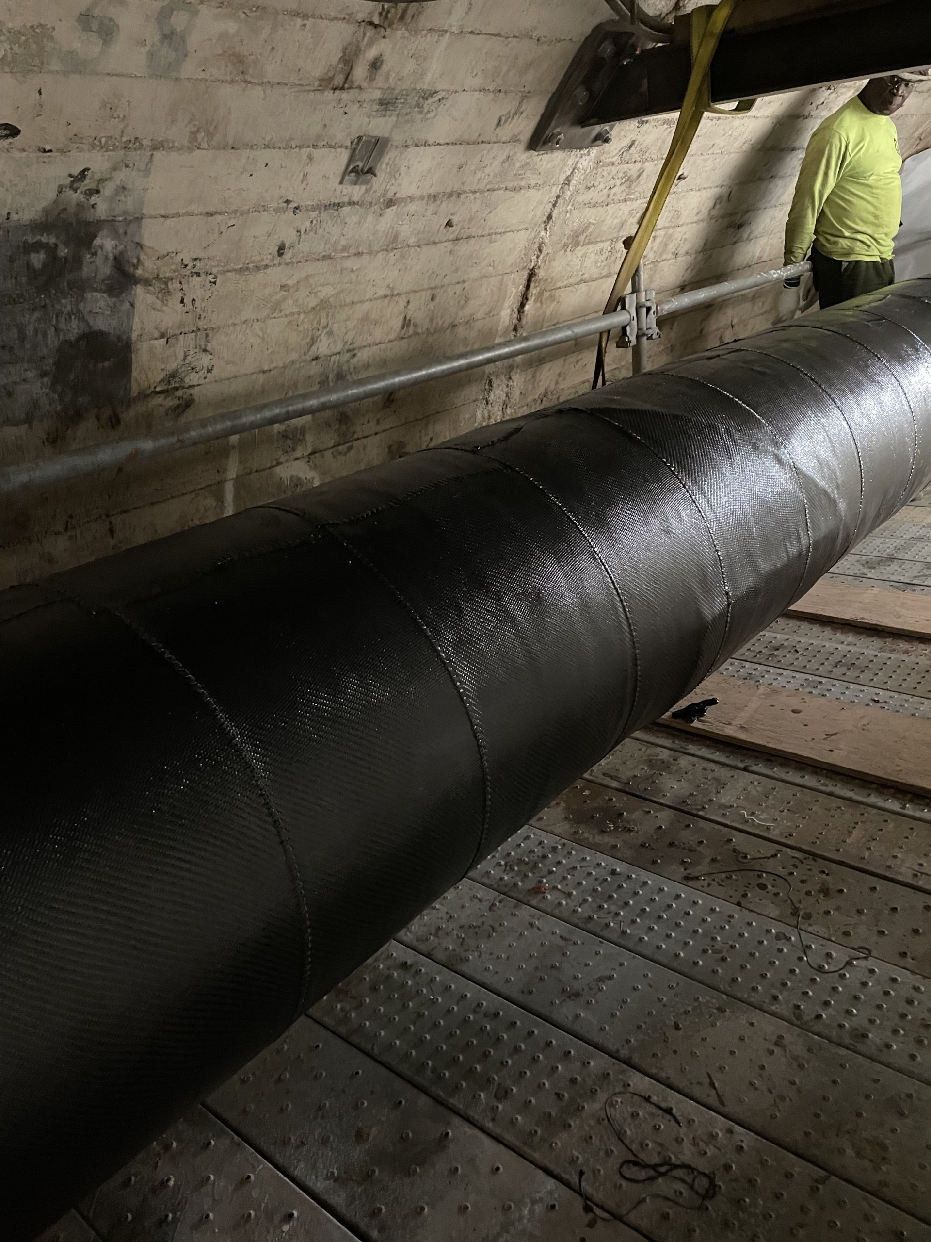 Composite pipe repair for underground power transmission pipe-type cable.