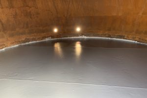 View of the inside of tank with epoxy coating on the floor of the tank.