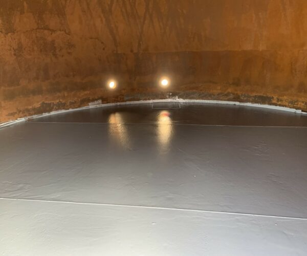 Repaired and coated bottom of the inside of a large tank