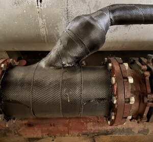 View of complex geometry on a wastewater pipe covered in a composite pipe repair.