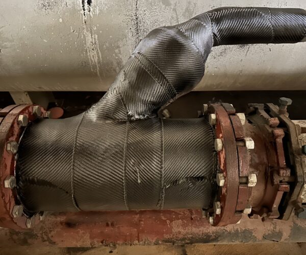 View of complex geometry on a wastewater pipe covered in a composite pipe repair.