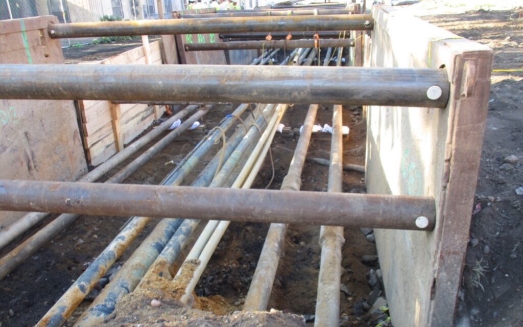 View of crowded pipe type cables power transmission lines