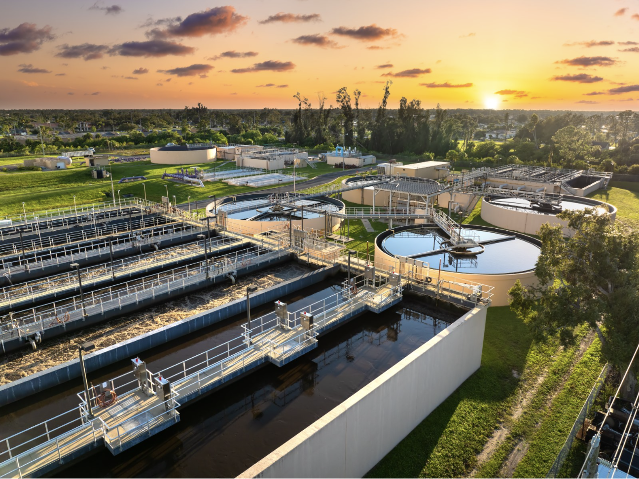 Water and wastewater industrial site with the sun setting in the background